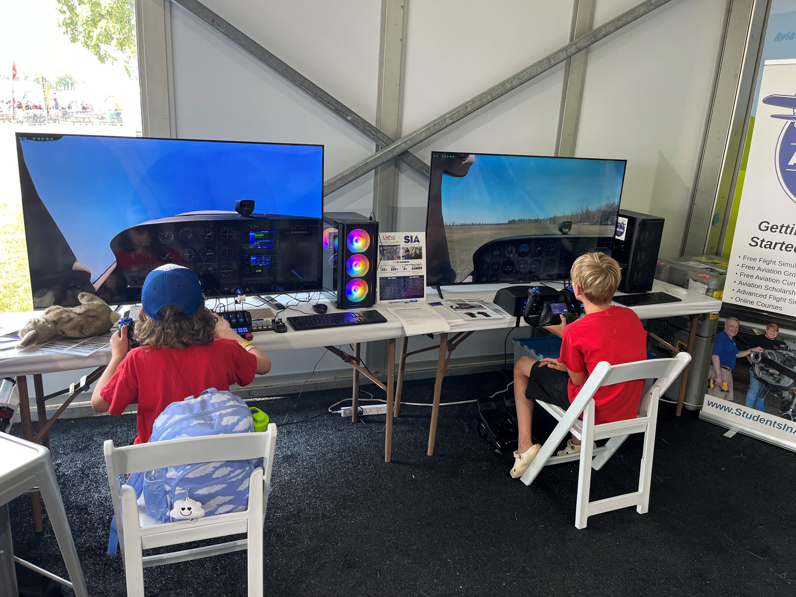 Young aviators try out the SIASims at AirVenture 2024