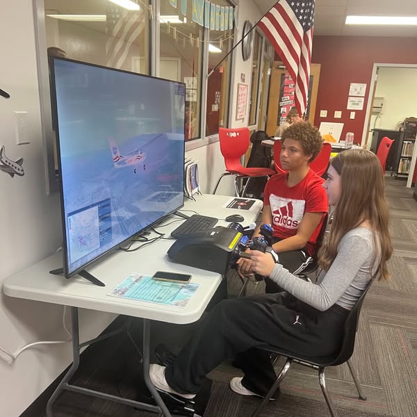 Milton students try out newly donated SIA Sim flight simulator